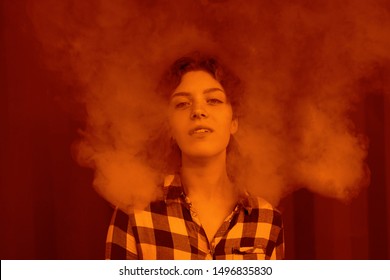 Young Woman Who Are Secretly Smoking At School. Smoking Girl.Vape Party. Young Woman With Glamorous Mystical Makeup Vaping In Nightclub (exhaling Smoke)            