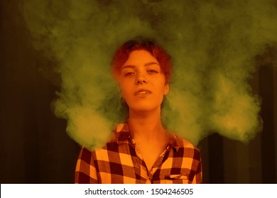 Young Woman Who Are Secretly Smoking At School. Smoking Girl.Vape Party. Sexy Young Woman With Glamorous Mystical Makeup Vaping In Nightclub (exhaling Smoke)            