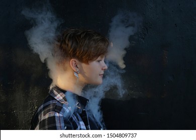 Young Woman Who Are Secretly Smoking At School. Smoking Girl.Vape Party. Sexy Young Woman With Glamorous Mystical Makeup Vaping In Nightclub (exhaling Smoke). 