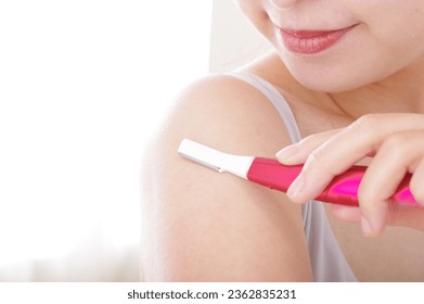 A young woman who treats unwanted hair on her arms