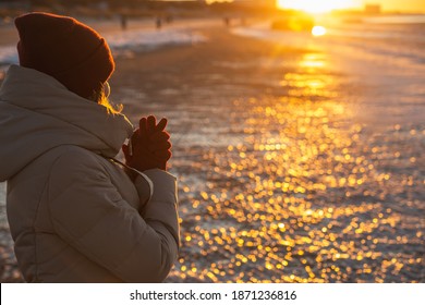 Young Woman Winter Enjoying Winter Sun. Red Sunset Light. Winter Solstice.