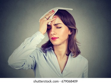 Young Woman Wipes Sweat From Her Forehead With A Handkerchief