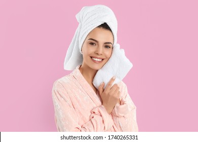 Young Woman Wiping Face With Towel On Pink Background