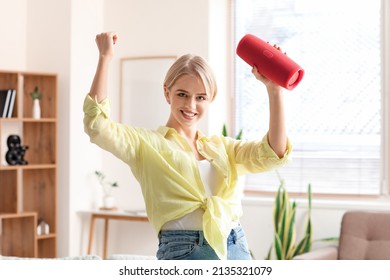 Young Woman With Wireless Portable Speaker Dancing In Light Room