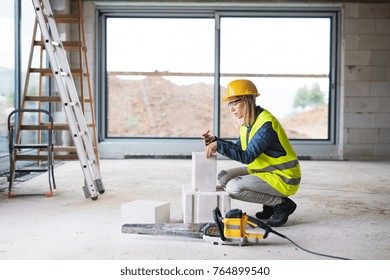 Young Woman Worker On The Building Site.