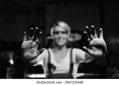 Young Woman Worker Showing Her Dirty Hands Indoors In Metal Workshop