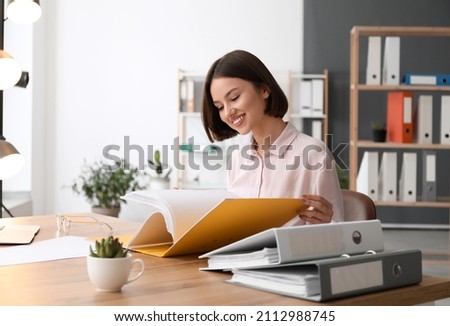 Young woman working with documents in office 商業照片 © 