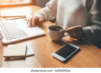 Young woman working in a home office on her laptop computer. Remote work concept. - Powered by Shutterstock