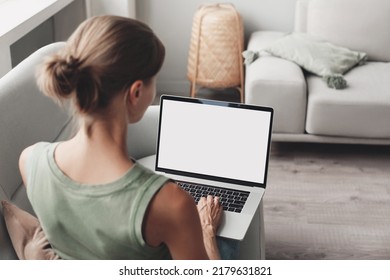 Young Woman Working At Home, Using Laptop Computer With Blank White Screen Display Mockup. Student Girl Looking At Laptop Screen. Online Shopping, Web Site, Working From Home, Online Learning Studying