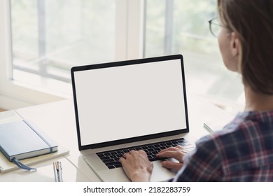 Young Woman Working At Home, Using Laptop Computer With Blank White Screen Display Mockup. Student Girl Looking At Laptop Screen. Online Shopping, Web Site, Working From Home, Studying Online Learning