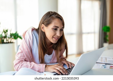 Young Woman Working Laptop. Business Woman Busy Working On Laptop Computer At Office. Businesswoman Sitting At Bright Modern Work Station And Typing On Laptop