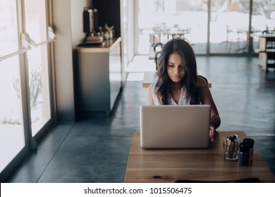 Young Woman Working Laptop In Coffee Shop