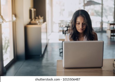 Young Woman Working Laptop In Coffee Shop