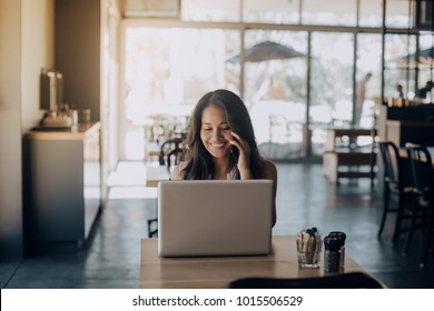 Young Woman Working Laptop In Coffee Shop