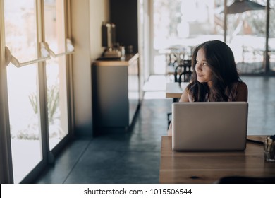 Young Woman Working Laptop In Coffee Shop