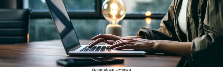 Young woman working with a laptop. Female freelancer connecting to internet via computer. Blogger or journalist writing new article. Close-up of female hands typing on keyboard - Shutterstock ID 1797065116