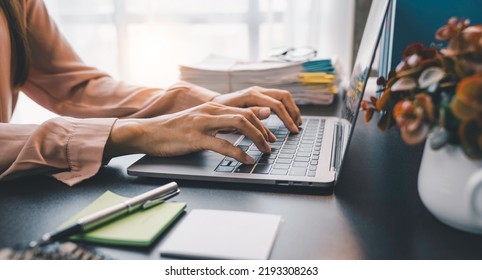 Young Woman Working With A Laptop. Female Freelancer Connecting To Internet Via Computer. Blogger Or Journalist Writing New Article.