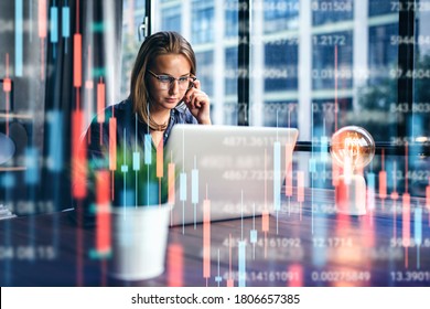 Young woman working at modern office.Technical price graph and indicator, red and green candlestick chart and stock trading computer screen background. Double exposure. Trader analyzing data - Powered by Shutterstock