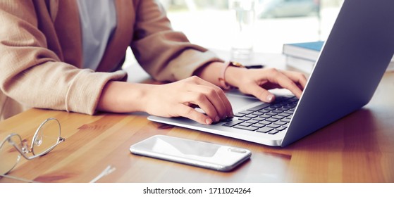 Young woman working on computer at table in office, closeup. Banner design - Shutterstock ID 1711024264
