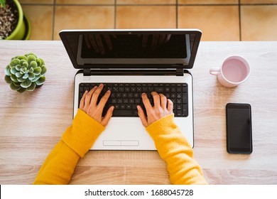 Young Woman Working On Laptop And Mobile Phone At Home. Work From Home, Stay Safe During Coronavirus Covid-2019 Concpt