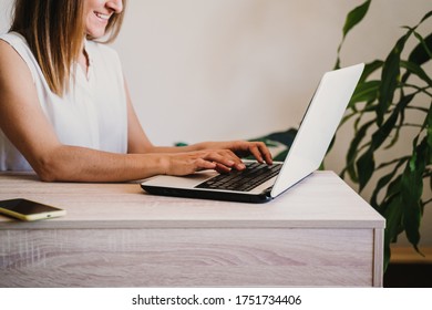 young woman working on laptop at home. work from home, stay safe during coronavirus covid-2019 concept - Shutterstock ID 1751734406