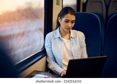 Young Woman Working On Laptop While Commuting By Train. Copy Space.