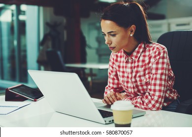 Young woman working on laptop in the office - Shutterstock ID 580870057