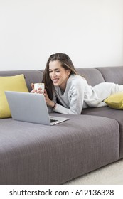 Young Woman Working On Laptop At Home. Morning Scene