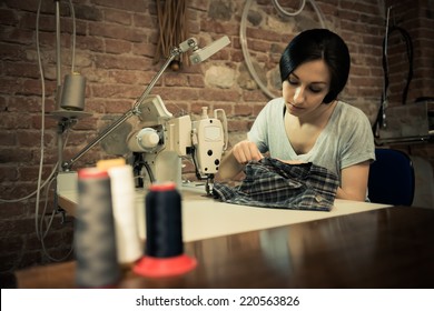 Young woman working on sewing machine