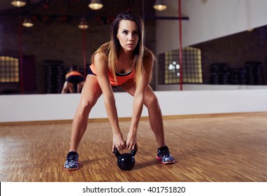 Young Woman Working Out With Kettlebell, Kettlebell Swing Exercise At Gym