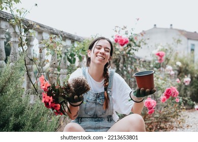 Young Woman Working Planting And Transplant Flowers In Garden .Concept Of Plant Care, Home Gardening. Young Woman Florist Taking Care Of Pot Plants