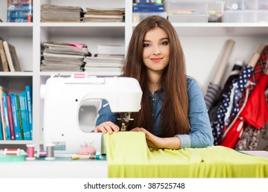 Young woman working with a sewing machine - Powered by Shutterstock