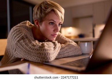 Young Woman Working Or Studying On Laptop At Home At Night Staring At Screen