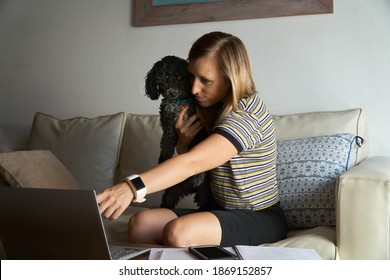 Young Woman Works From Home Office. Successful Woman. Freelancer Workplace. Female Business. Lifestyle Authentic Moment With A Dog