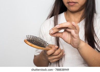 Young Woman Worried About Hair Loss On A White Background