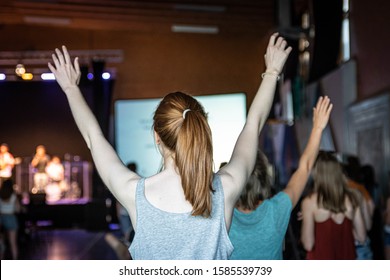 Young Woman Is Worshipping At A Service In A Church