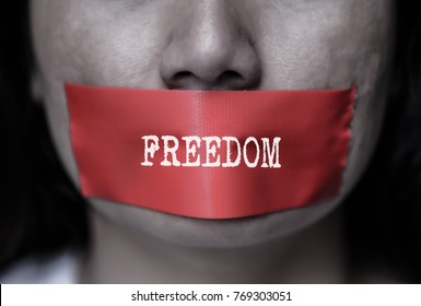 Young woman was wrapping her mount by adhesive tape,  Concept freedom of speech, censorship, freedom of press. International Human Right day.