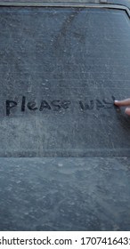 A Young Woman Writes With A Finger On A Dirty Car 