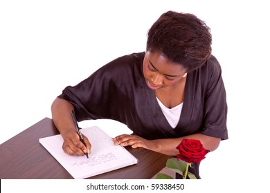 A young woman writes a letter