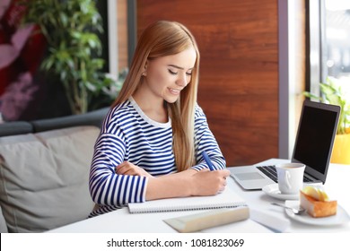 Young Woman Writing Letter At Table In Cafe. Mail Delivery