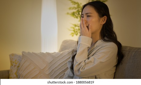 Young Woman Yawning On The Sofa