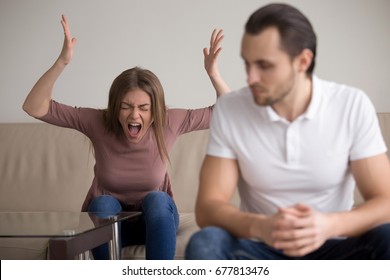 Young woman yelling at boyfriend in hysterics, drama queen screaming loud shouting at husband trying to get attention, having a tantrum, lack of emotional intelligence, manipulation in relationships