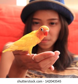 Young Woman With Yellow Bird On The Hand