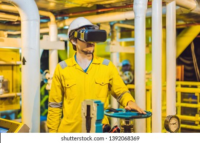 Young Woman In A Yellow Work Uniform, Glasses And Helmet Uses Virtual Reality Glasses In Industrial Environment, Oil Platform Or Liquefied Gas Plant