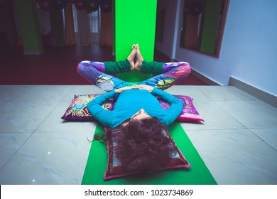 Young Woman In Yoga Relaxing Pose With Legs Up The Wall Full Body Shot