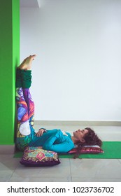 Young Woman In Yoga Relaxing Pose With Legs Up The Wall Side View Indoor