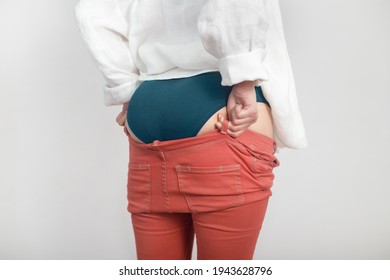 Young Woman's Bottom Doesn't Fit In Last Year's Pants. Diet, Overweight, Obesity Concept.