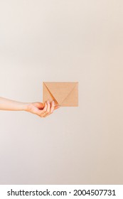 Young Woman's Hand Holding A Kraft Envelope 