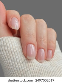 Young woman's hands with light manicure and light background _ Soft woman's hands with transparent manicure 