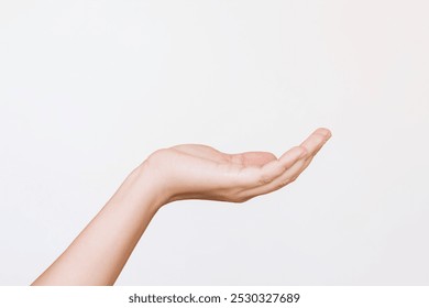 A young woman's outstretched hand making a gesture like holding something or asking for help isolated on a white background. Mockup with empty copy space for a intended object - Powered by Shutterstock